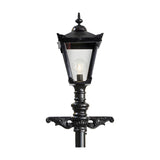 Victorian cast iron lamp post in black with a tapered four-sided glass lantern head, cast finial, decorative scroll bracket base, and visible bulb, shown against a plain white background.