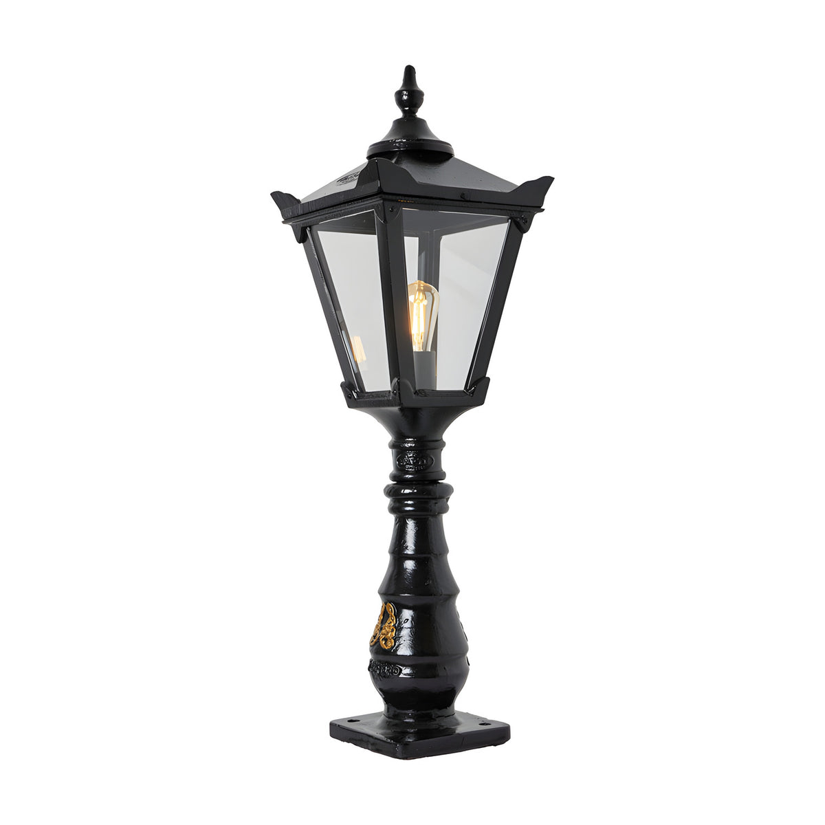 Large black Victorian cast iron pedestal post light with tapered four-sided lantern head, clear glass panels, stepped crown and cast finial atop an ornate column.