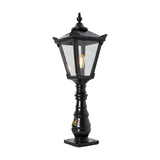 Large black Victorian cast iron pedestal post light with tapered four-sided lantern head, clear glass panels, stepped crown and cast finial atop an ornate column.