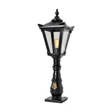 Large Victorian cast iron pedestal post light in black, tapered four-sided lantern head with stepped crown and finial on a decorative pillar base, shown against a plain white background.