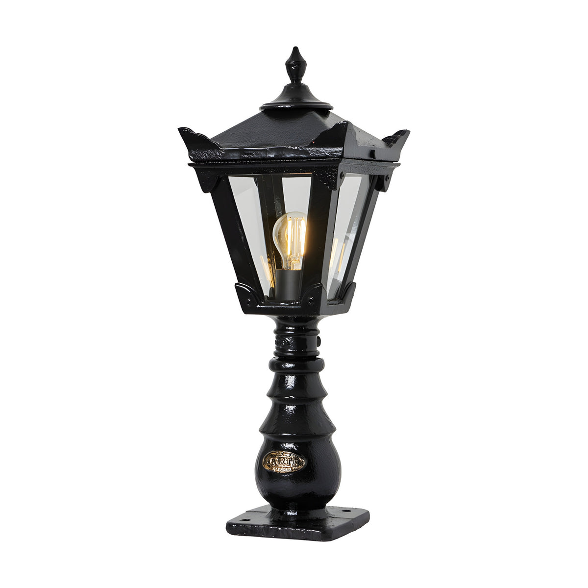 Small Victorian cast iron pedestal post light in black, tapered four-sided lantern head with stepped crown and finial, glass panels, single E27 bulb, on a white background.