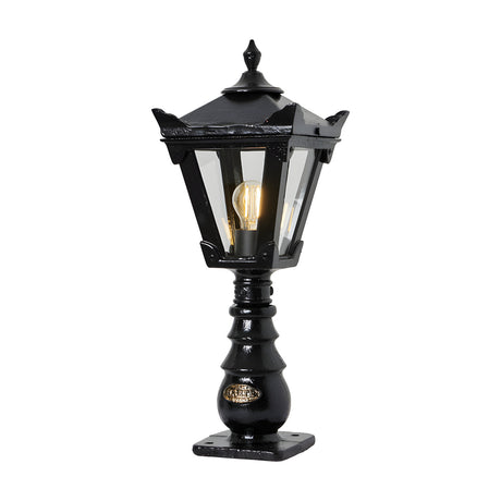 Small Victorian cast iron pedestal post light in black, tapered four-sided lantern head with stepped crown and finial, glass panels, single E27 bulb, on a white background.