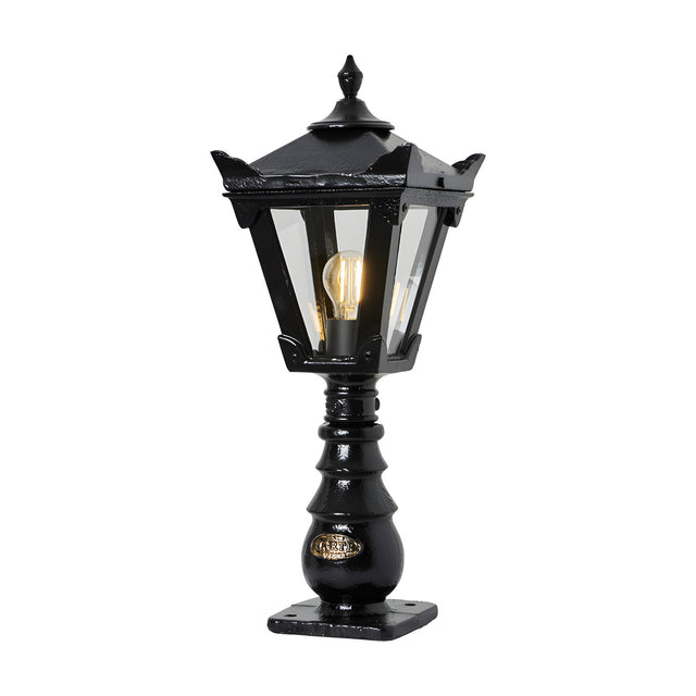 Small Victorian cast iron pedestal post light in black, tapered four-sided lantern head with stepped crown and finial, glass panels, single E27 bulb, on a white background.