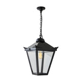 Large Victorian cast iron hanging lantern in black, tapered four-sided glass panels, stepped crown with corner tips, suspended by chain from a ceiling rose on a plain white background.