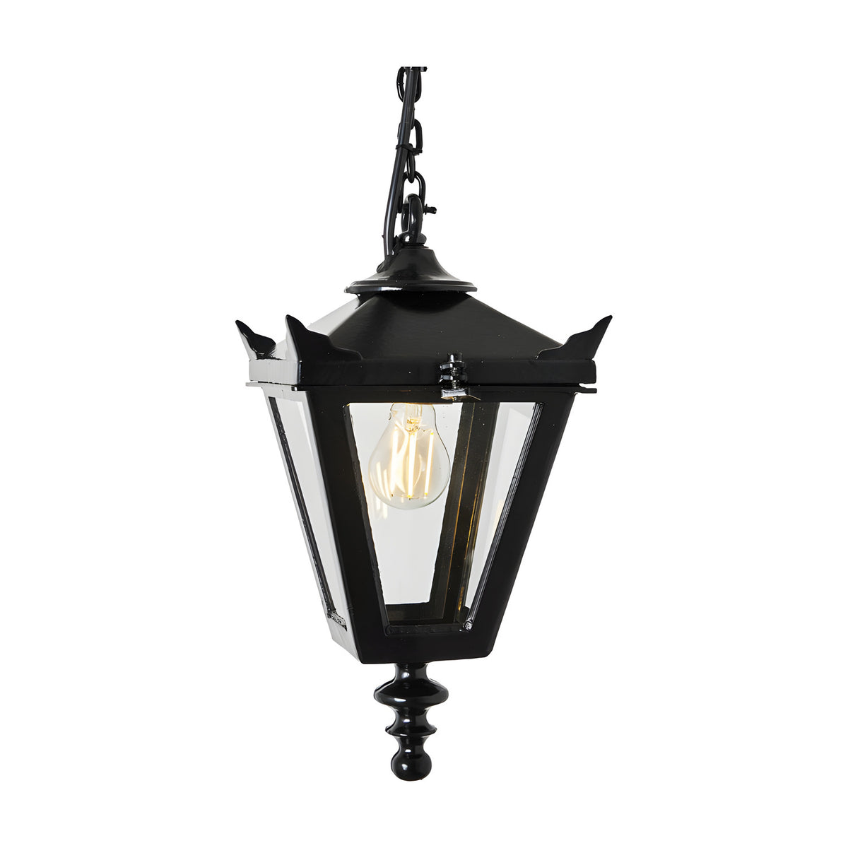 Small Victorian cast iron hanging lantern in black with tapered four-sided glass panels, corner tips, stepped crown and cast finial, suspended on a chain against a plain white background.