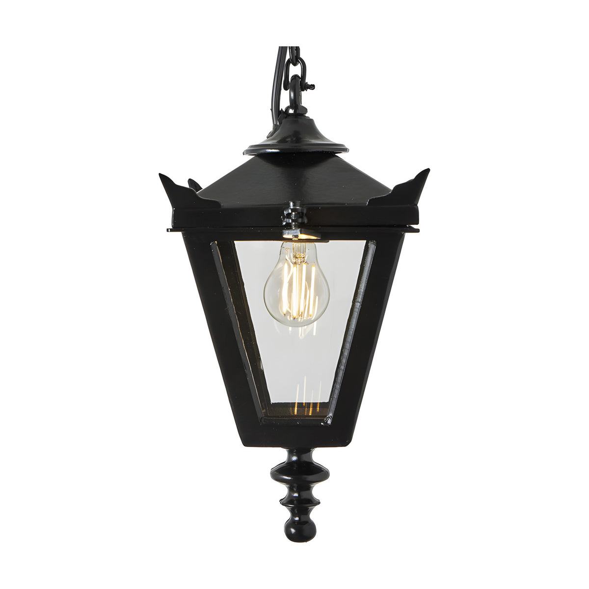 Small Victorian cast iron hanging lantern in black with a tapered four-sided glass head, stepped crown, corner tips, cast finial and chain, shown lit against a plain white background.