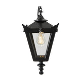 Small Victorian cast iron hanging lantern in black with a tapered four-sided glass head, stepped crown, corner tips, cast finial and chain, shown lit against a plain white background.