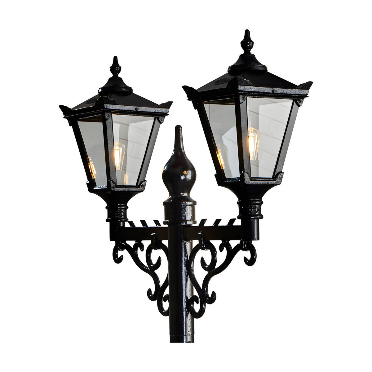 Black Victorian cast iron double-headed lamp post with two tapered four-sided lantern heads, clear glass panels, scrolled brackets and a central finial.