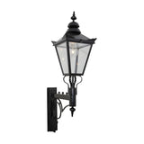 Large Victorian wall lantern in black, tapered four-sided glass head with stepped crown and finial, mounted on a scroll bracket, E27 bulb visible, plain white background.