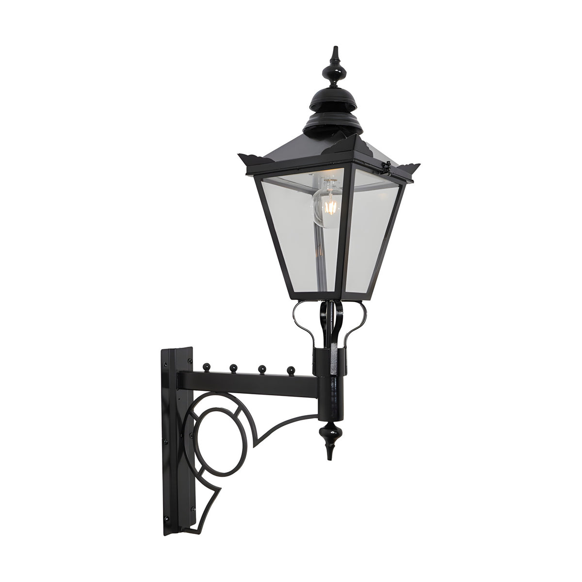 Large Victorian wall lantern in black with tapered four-sided glass head, stepped crown, cast finial, and scroll bracket, shown on a plain white background.