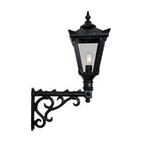 Medium Victorian wall lantern in black, tapered four-sided glass shade with cast finial, mounted on a decorative scroll bracket, shown on a plain white background.