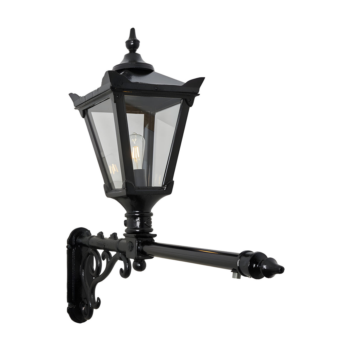 Victorian cast iron wall lantern in black with a tapered four-sided glass head, stepped crown, finial top, and scrolled bracket on a long extended arm, shown on a plain white background.