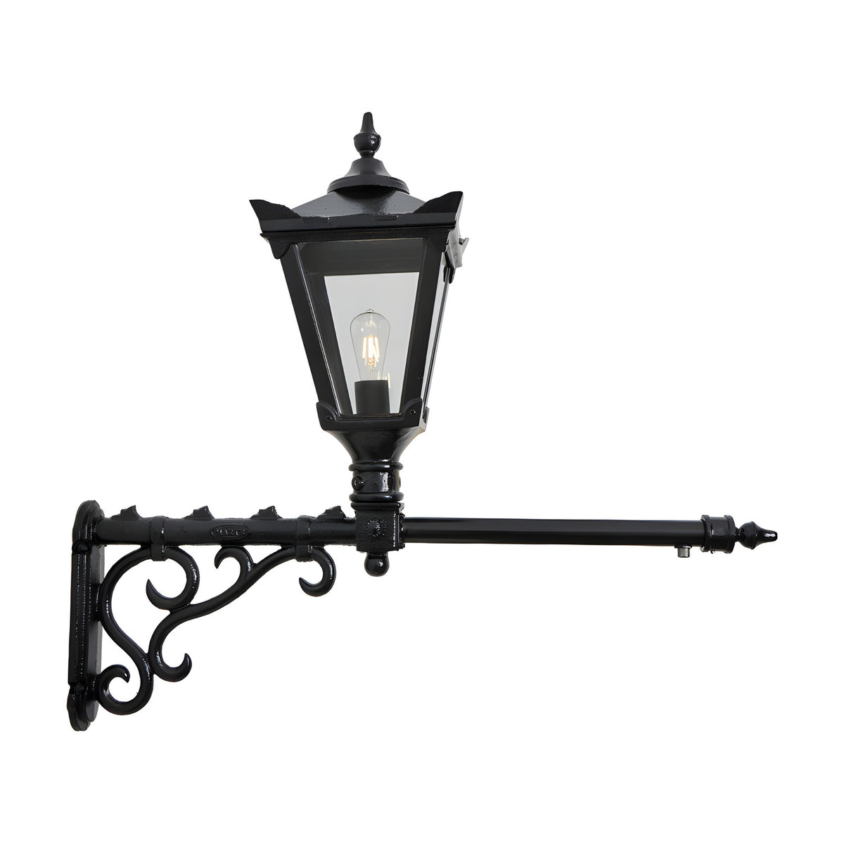 Victorian cast iron wall lantern in black with a tapered four-sided glass head, stepped crown, cast finial and scrolled long wall bracket, shown on a plain white background.