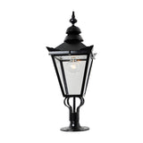 Large Victorian cast iron pillar light in black with a tapered four-sided glass panel head, stepped crown, and cast finial, mounted on a pier base against a plain white background.