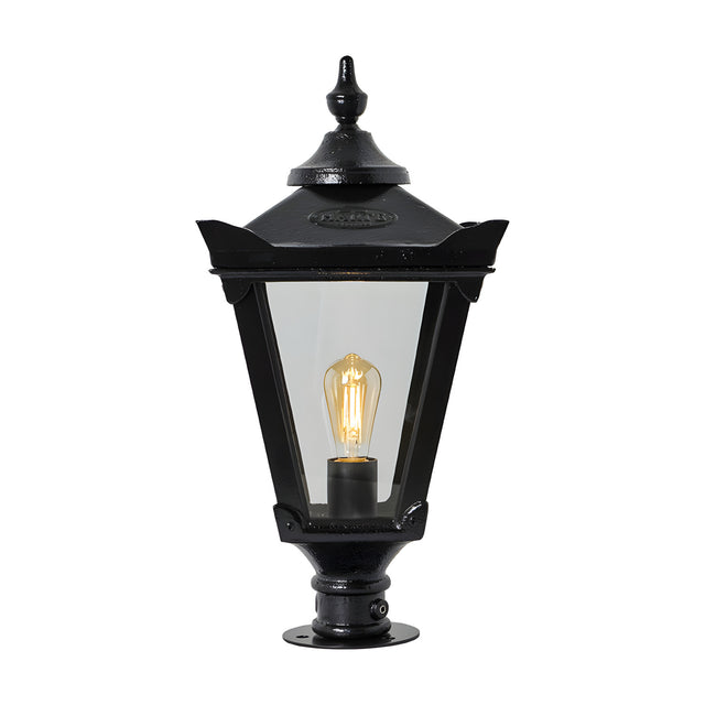 Large Victorian cast iron pillar light in black with tapered four-sided glass panels, stepped crown finial, and pier cap base, shown on a plain white background.