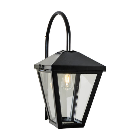 Contemporary downturned wall lantern in black metal with clear glass panels and a curved top bracket, shown lit with a visible bulb on a plain white background.