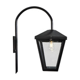 Contemporary downturned wall lantern in black steel with a curved arm, tapered glass panels and visible E27 bulb, shown on a plain white background.