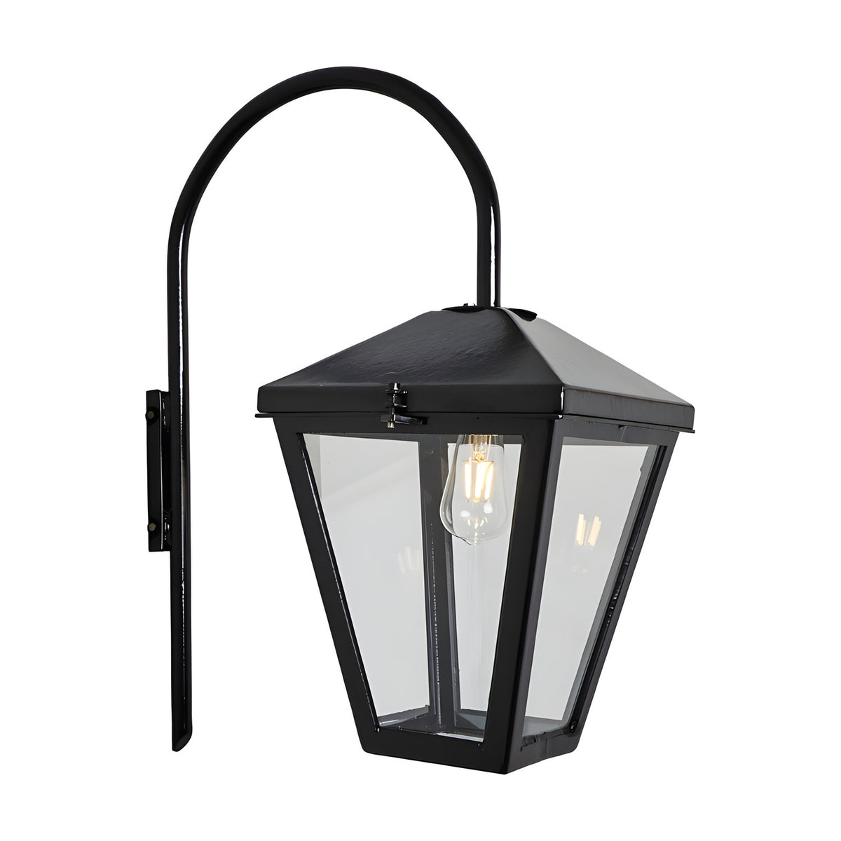 Contemporary downturned wall lantern in black steel with a tapered glass panel shade and curved gooseneck arm on a wall mount, shown lit with an E27 bulb against a plain white background.