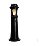 Medium Victorian cast iron bollard light in black, single stepped column with beaded rings and a frosted oval lens, illuminated, on a plain white background.