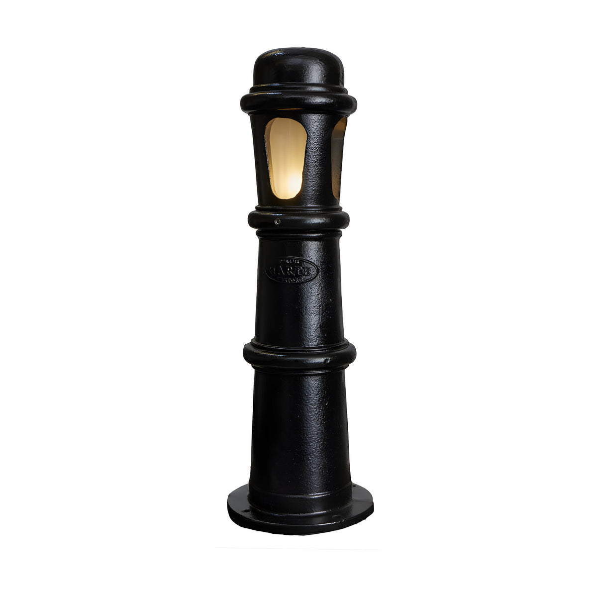 Large Victorian cast iron bollard light in black with frosted polycarbonate lens panels, stepped and beaded column design, illuminated, shown on a plain white background.
