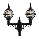 Victorian-style black cast iron double-headed lamp post with two banded globe lanterns and scrollwork brackets on ornate crossarm, shown against a plain white background.