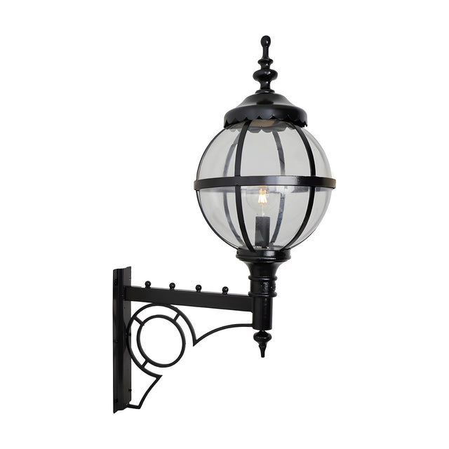 Large Victorian Globe Wall Lantern in black, a clear glass globe held in a banded iron cage on a decorative scroll bracket, shown on a plain white background.