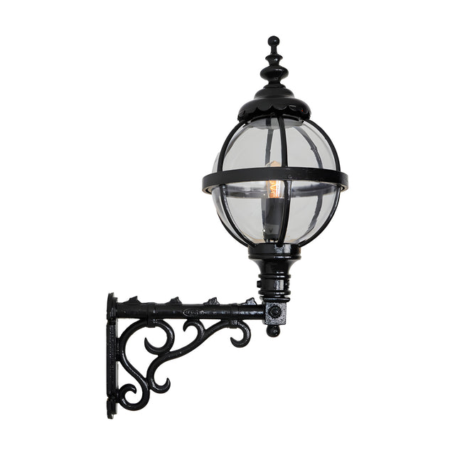 Medium Victorian globe wall lantern in black with a caged glass sphere on an ornate scroll bracket, shown on a plain white background.