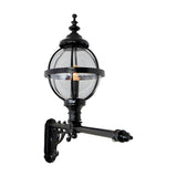 Victorian cast iron globe wall lantern in black, clear glass panels in a banded cage, mounted on a long decorative wall bracket against a plain white background.