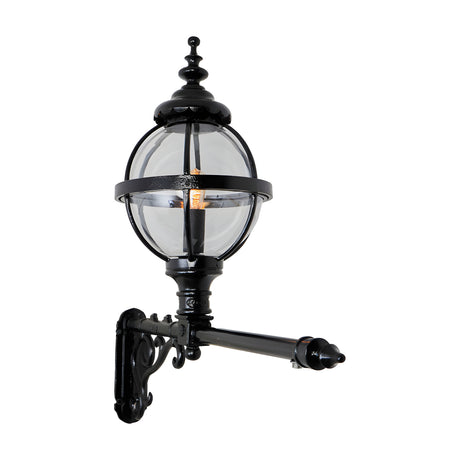 Victorian cast iron globe wall lantern in black, clear glass panels in a banded cage, mounted on a long decorative wall bracket against a plain white background.