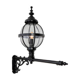 Victorian cast iron globe wall lantern in black, banded cage design with clear glass, mounted on a long scrolled wall bracket, shown on a plain white background.