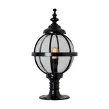 Medium Victorian Globe Pillar Light in black with a clear glass globe held by a banded iron cage on a turned pedestal base, lit E27 bulb visible, shown on a plain white background.