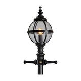 Victorian Manor cast iron globe lamp post in black, close-up of the banded glass globe with lit bulb and ornate finial atop the post, shown on a plain white background.