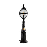 Victorian Manor cast iron globe pedestal post light in black, featuring a banded globe cage on a traditional column base with square footplate, on a plain white background.