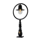 Large black cast iron railway-style pedestal post light with hoop frame, spun shade, clear glass dome, and decorative base with square fixing plate, on a white background.