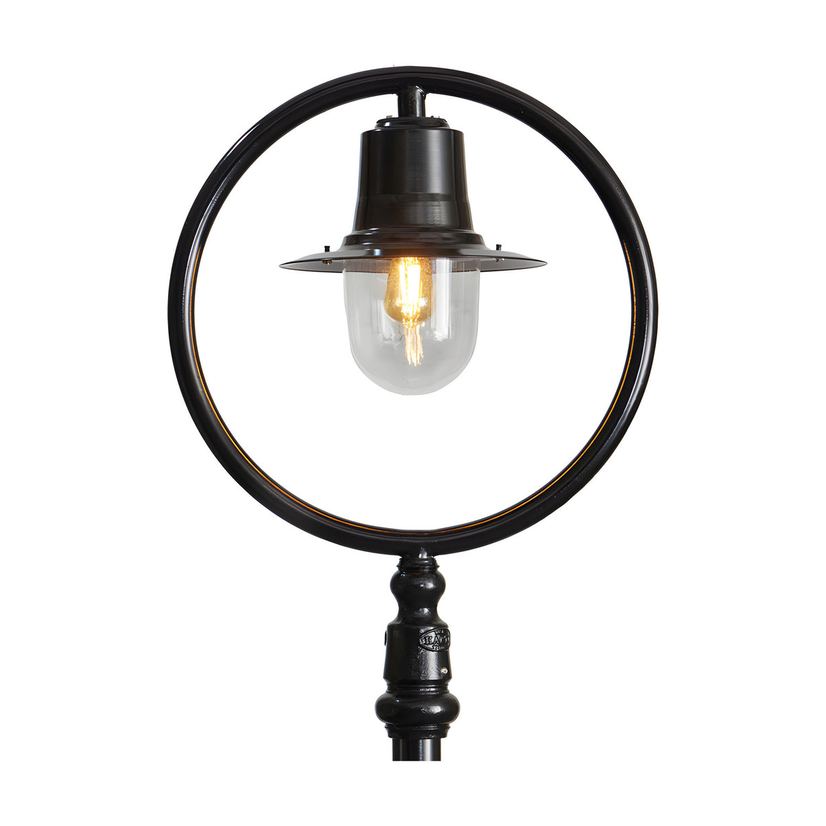 Railway style cast iron lamp post in black, showing a single light with spun shade and clear polycarbonate dome set within a round hoop bracket, on a plain white background.