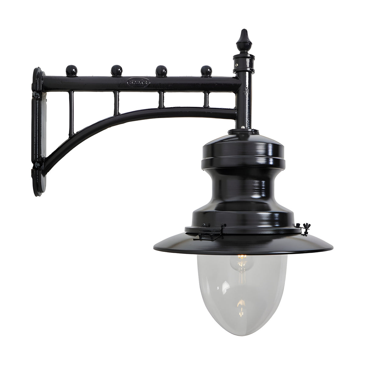 Large railway style wall lantern in black, with a trussed cast arm bracket, spun metal shade, and clear glass dome, shown on a plain white background.