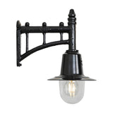 Small railway style black wall lantern on a trussed cast iron arm with a spun metal shade over a clear glass dome and visible bulb, shown on a white background.