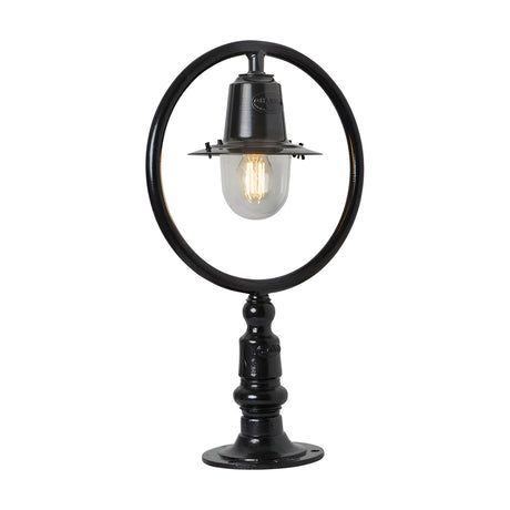 Small Railway Style Cast Iron Pillar Light in black, with a circular hoop frame over a spun shade and clear glass dome, mounted on a flat pier base, shown on a plain white background.