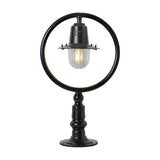 Small Railway Style cast iron pillar light in black, with a circular hoop frame, spun shade over a clear glass dome, and pedestal base for a flat pier, shown on a plain white background.