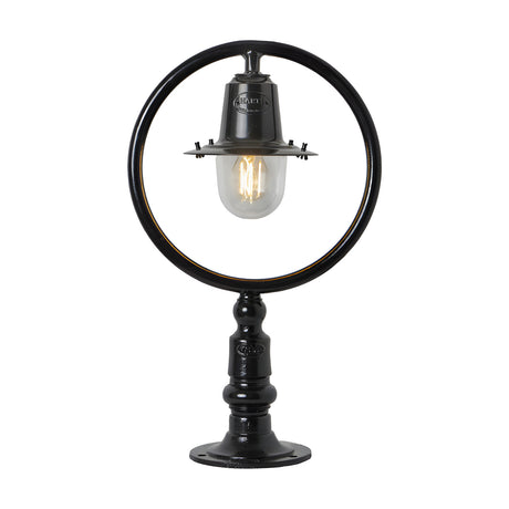 Small Railway Style cast iron pillar light in black, with a circular hoop frame, spun shade over a clear glass dome, and pedestal base for a flat pier, shown on a plain white background.