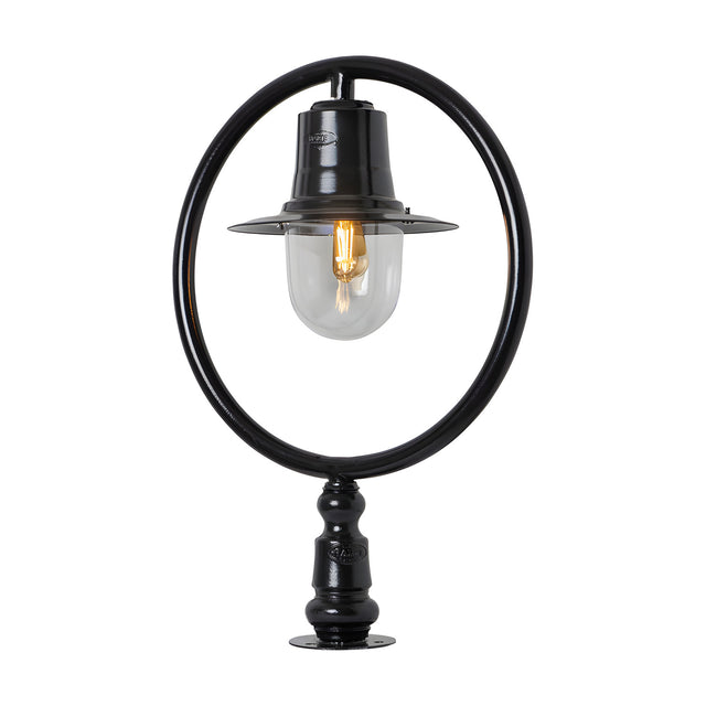 Black Railway Style Pillar Light for narrow piers, featuring a hoop frame, spun shade, and clear glass dome over a bulb, mounted on a pier cap base.