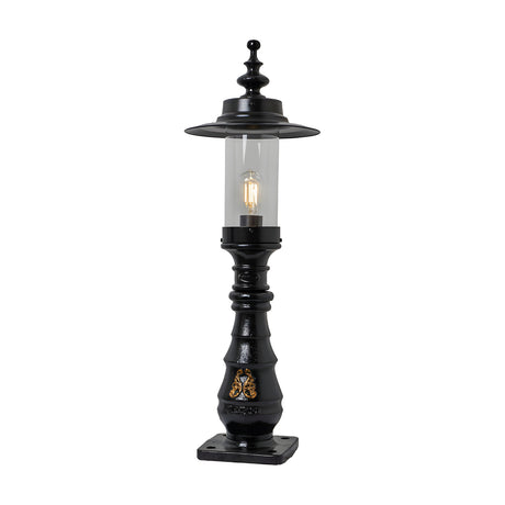 Large Georgian cast iron pedestal post light in black with clear glass shade, decorative crown top, ornate column detail, and square base plate on a plain white background.