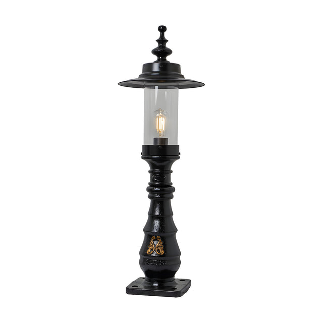 Large Georgian cast iron pedestal post light in black with clear glass shade, decorative crown top, ornate column detail, and square base plate on a plain white background.