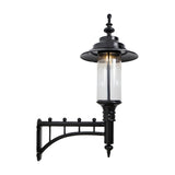 Large Georgian cast iron wall lantern in black with a decorative scroll bracket, clear cylindrical glass shade and domed crown, shown against a plain white background.