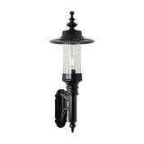 Medium Georgian Cast Iron Wall Lantern in black, single-light outdoor fixture with clear glass cylinder, exposed bulb, wide flat top shade and cast bracket arm, shown on a plain white background.