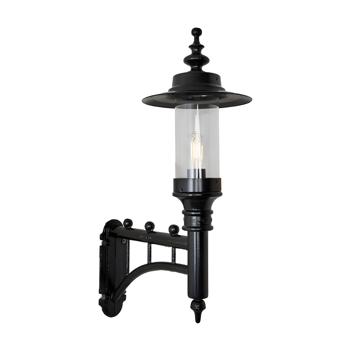 Medium Georgian Cast Iron Wall Lantern in black with a scrolled bracket, cylindrical clear glass shade, and pointed finial, shown against a plain white background.