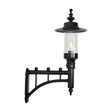Medium Georgian Cast Iron Wall Lantern in black with a decorative scroll bracket, clear glass cylinder shade, and visible bulb, shown on a plain white background.