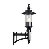 Small Georgian cast iron outdoor wall lantern in black, single-light with clear cylindrical glass shade and decorative wall bracket, shown on a plain white background.