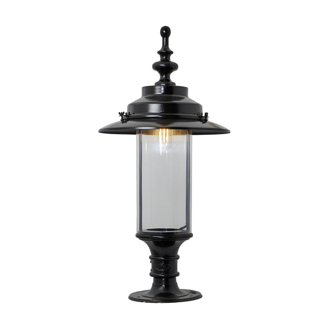 Georgian cast iron pillar light in black with domed crown, clear cylindrical glass panel, and pedestal base, shown on a plain white background.