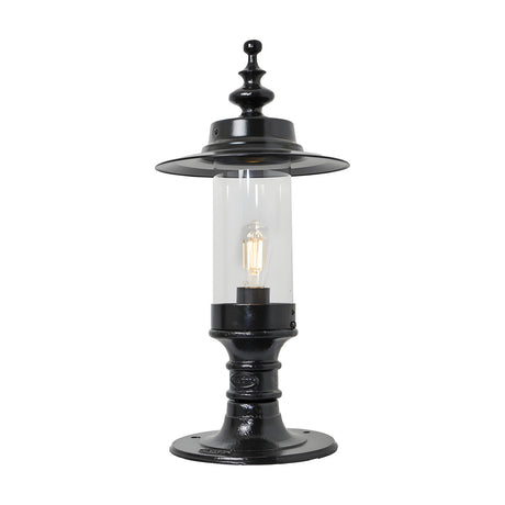 Large Georgian cast iron pillar light in black with a shallow crown-shaped hood, clear cylindrical glass shade, and flat pier cap base, shown on a white background.